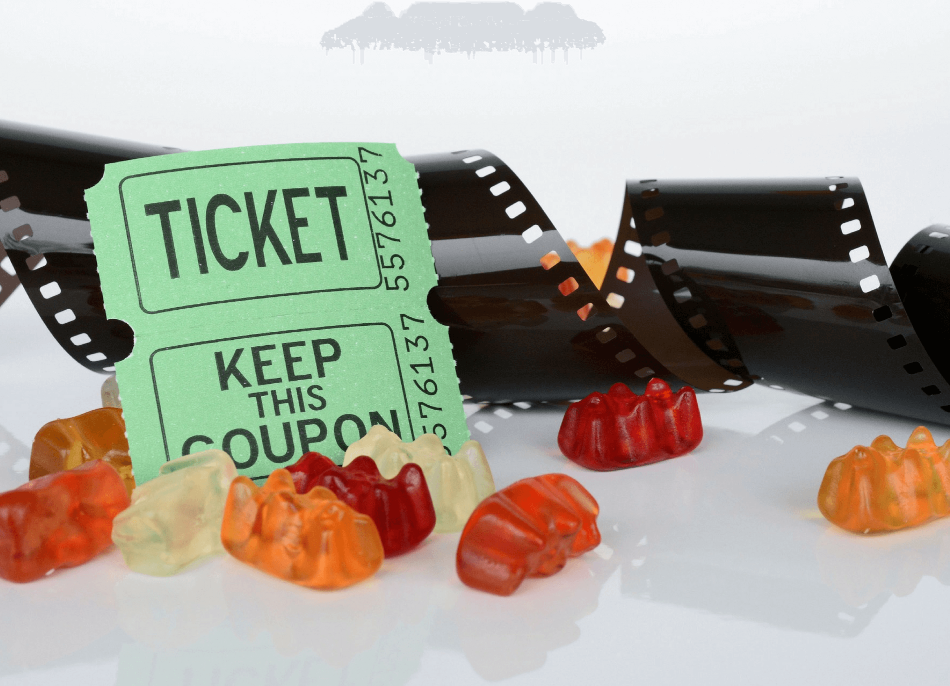 movie tickets with a reel of film and gummy bears