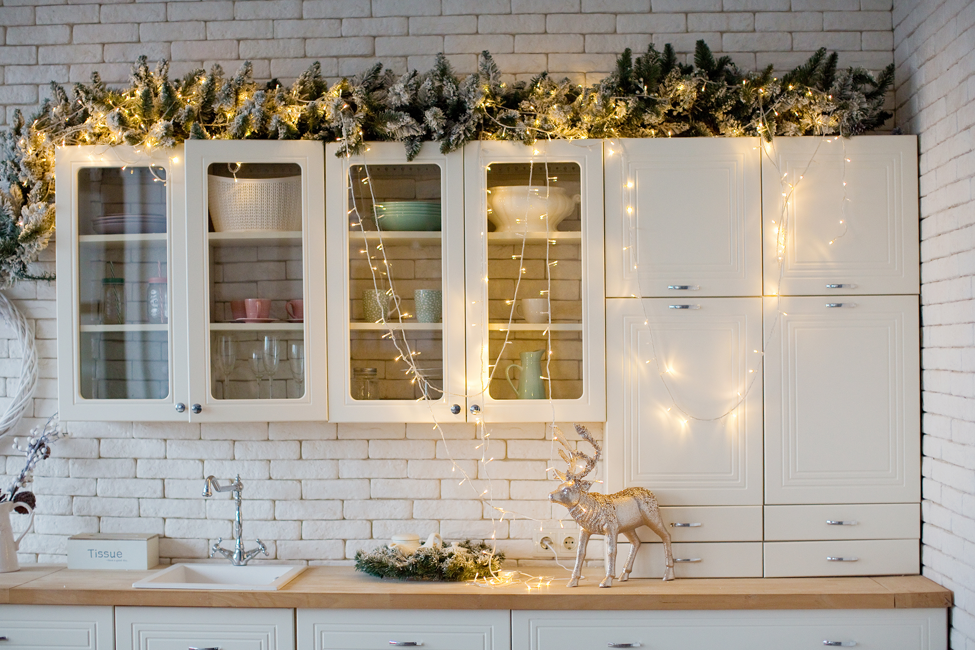 garland draped over tops of kitchen cabinets