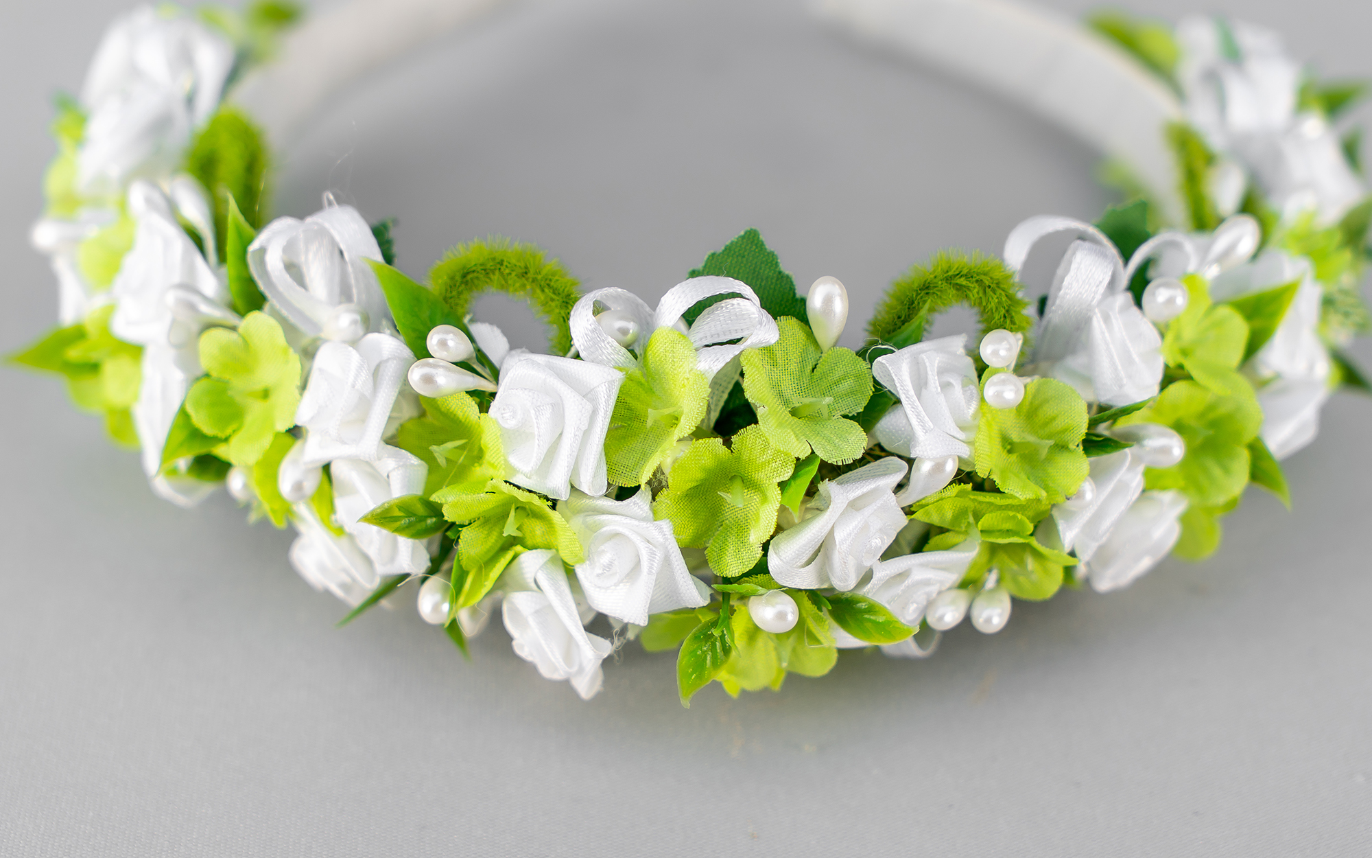 spring wreath with bright green leaves and tiny white silk roses