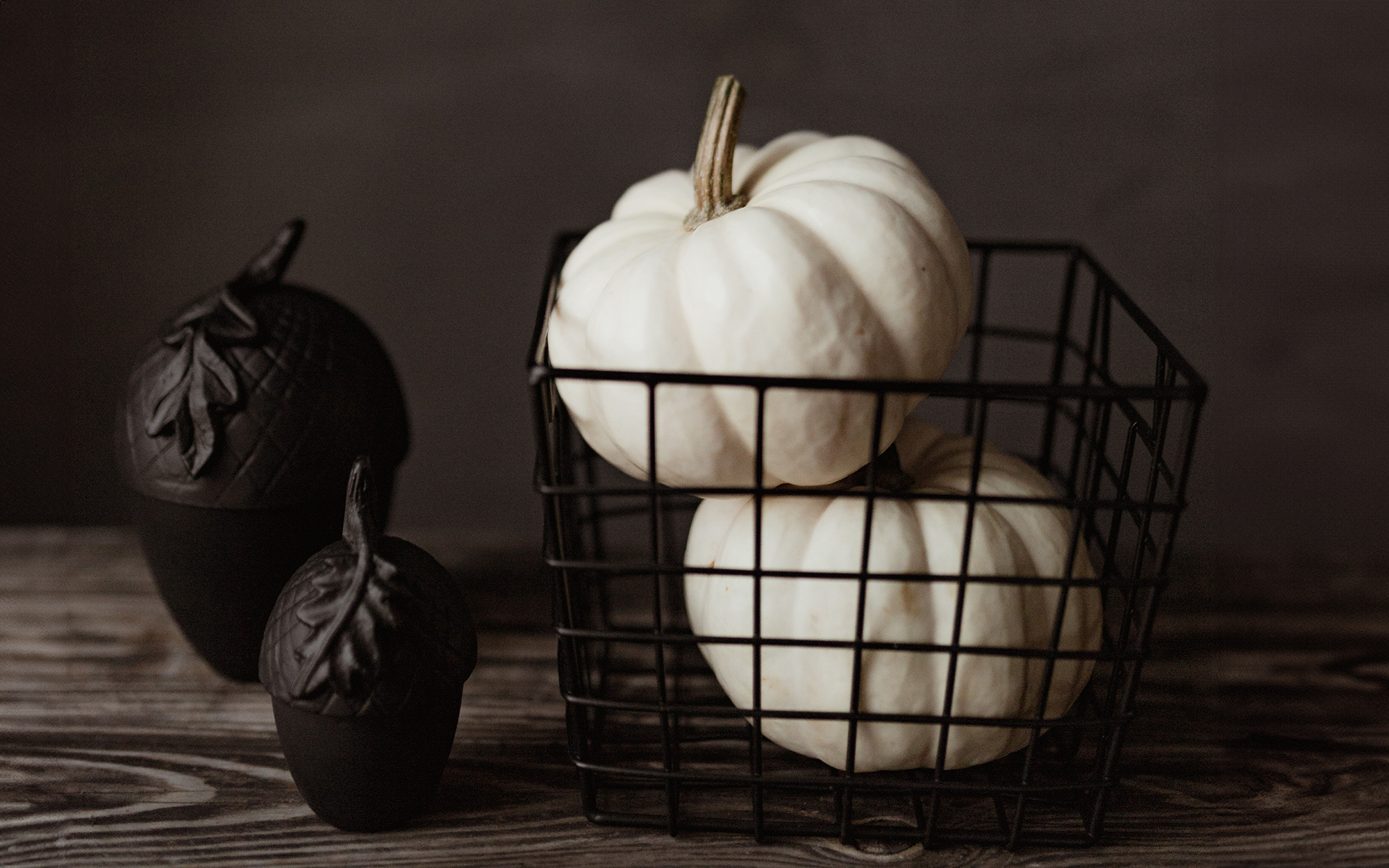 black acorn decorations, black wire basket filled with white pumpkins black acorn decorations, black wire basket filled with white pumpkins