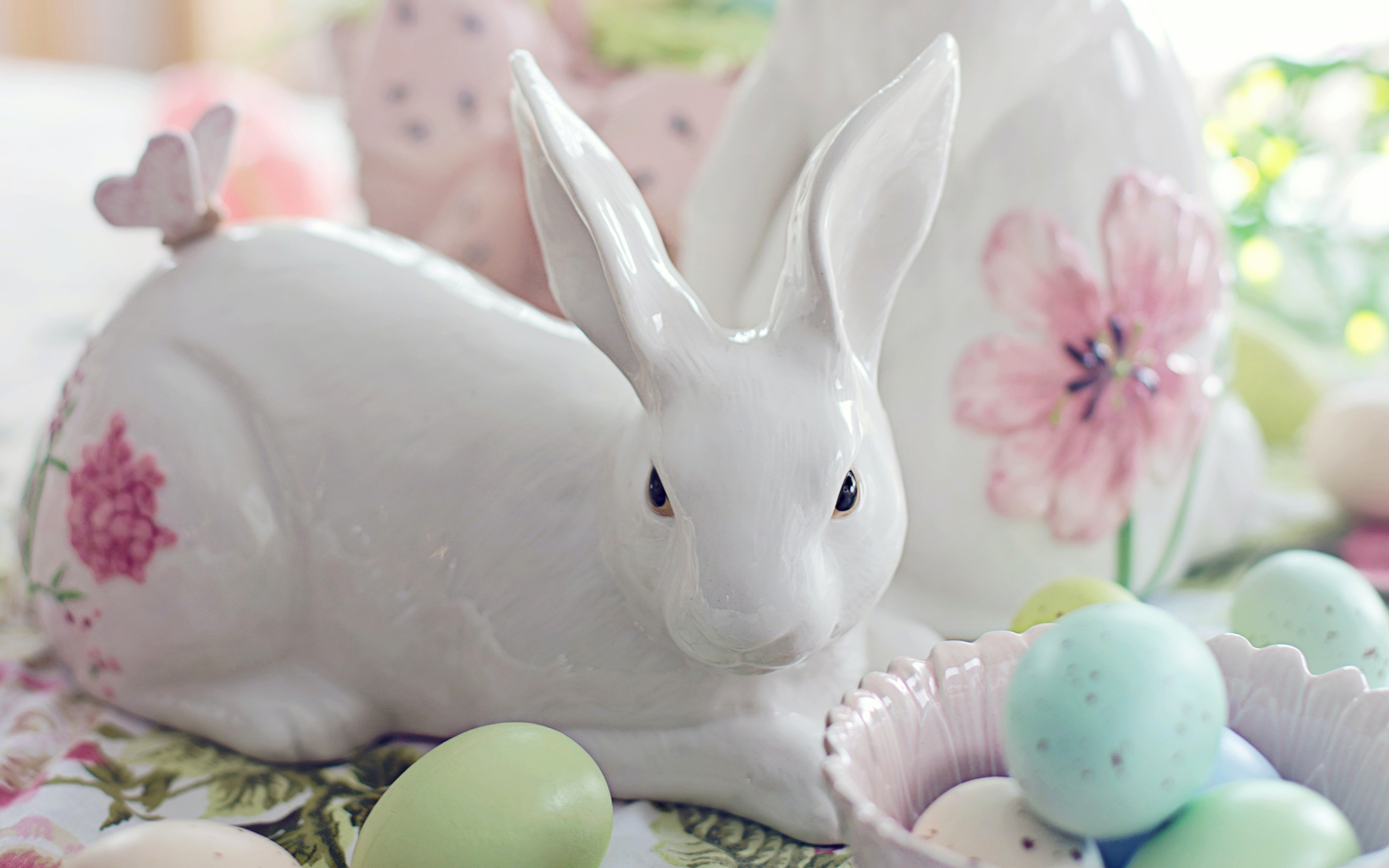 lovely ceramic bunny surrounded by pastel Easter eggs and decorations