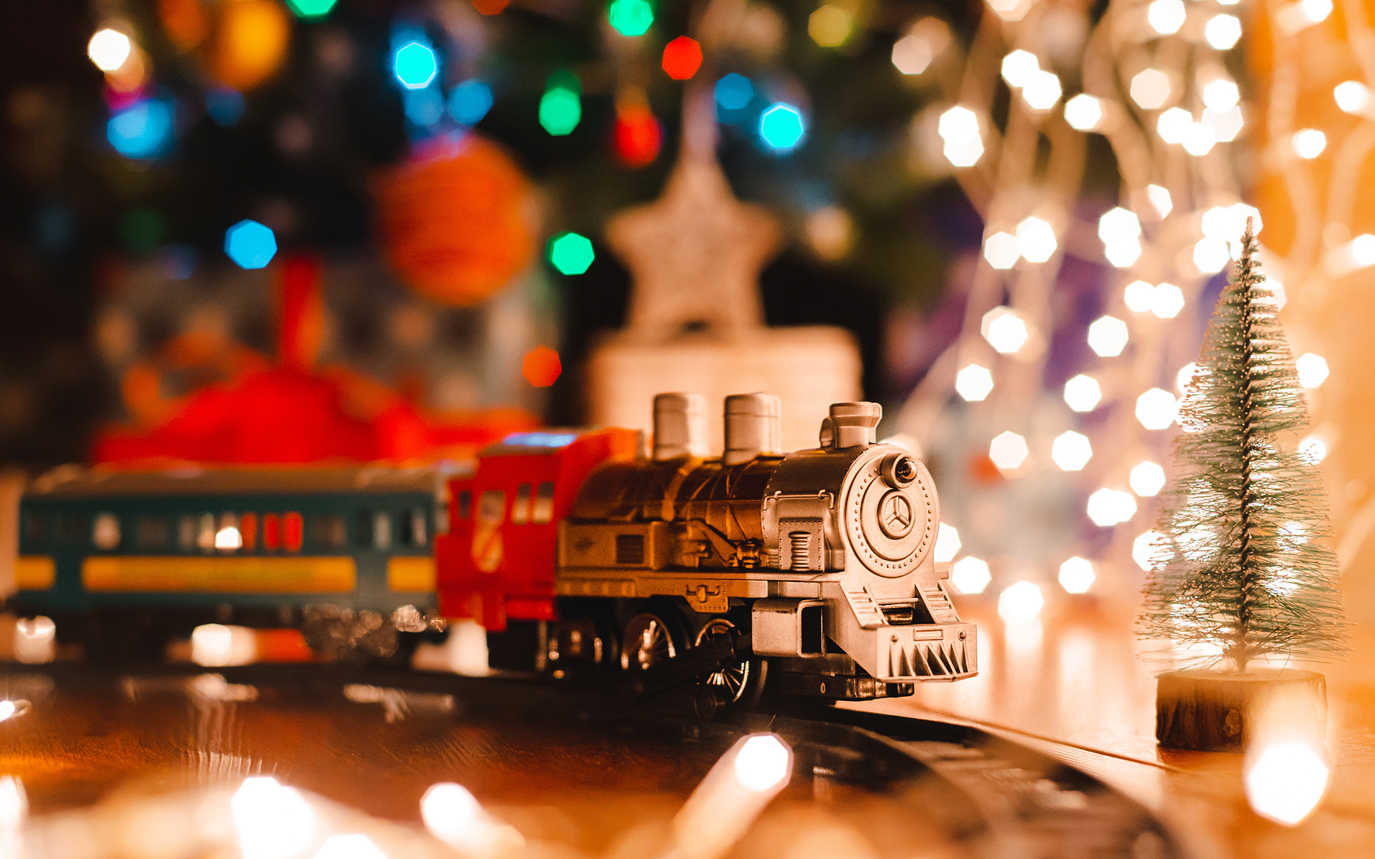 classic model Christmas train with Christmas tree bokeh background